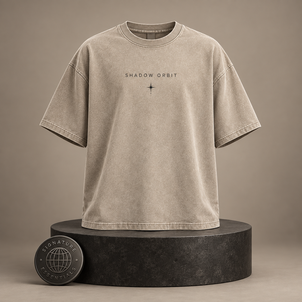 Shadow Orbit beige T-shirt front on round Signature Essentials pedestal