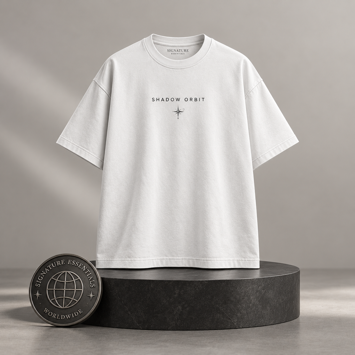 Shadow Orbit white T-shirt front on round Signature Essentials pedestal